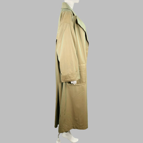 Side view of chartreuse-green long coat showing sleeve, cuff detail, and side pocket.