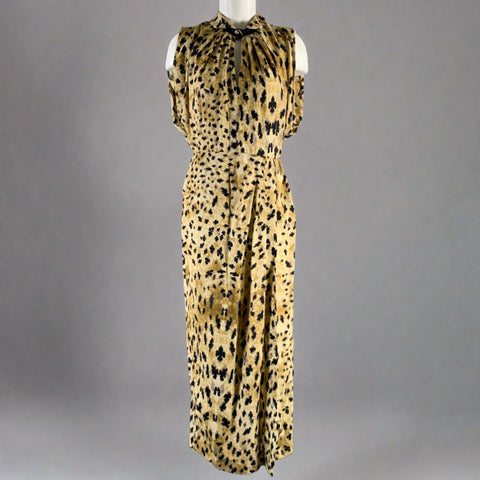 Front view of beige and black abstract-print Prada sleeveless dress on a mannequin, with gathered neckline and long skirt.
