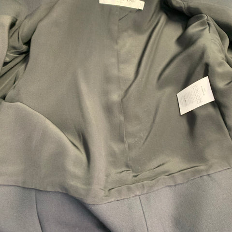 Interior view of the black blazer lining with Christian Dior label and care tag.