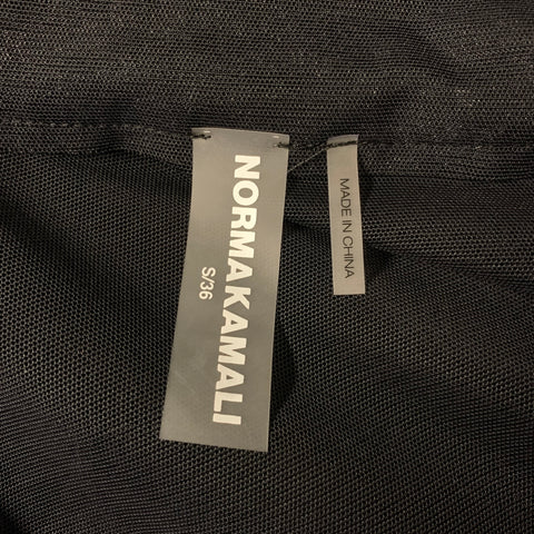 Close-up of Norma Kamali size S/36 and Made in China labels.