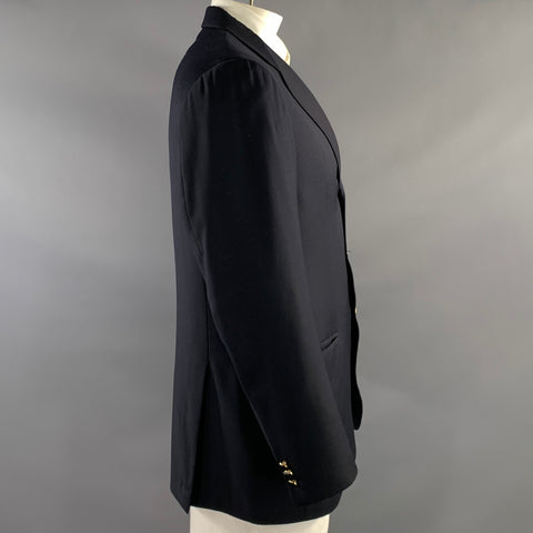 Side view of navy sport coat showing long sleeve, tailored profile, and cuff buttons.
