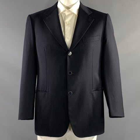 Front view of navy Brioni sport coat on mannequin with notch lapels, three-button front, chest pocket, and flap hip pockets.