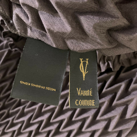 Close-up of VANITE COUTURE brand label and Made in Hong Kong tag.