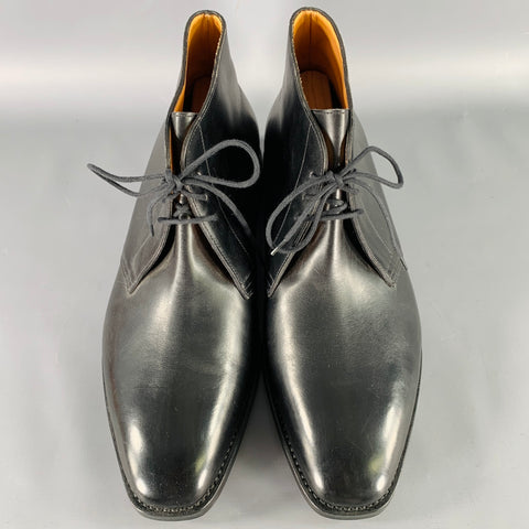 Top view of black leather lace-up ankle boots with tan leather lining.