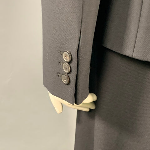 Close-up of the blazer cuff with three dark buttons and sleeve vent.