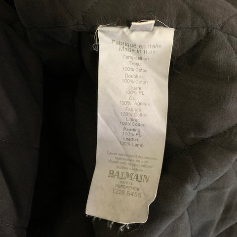 Interior composition label stating Made in Italy, 100% cotton fabric and lining, 100% polyester padding, and 100% lamb leather.