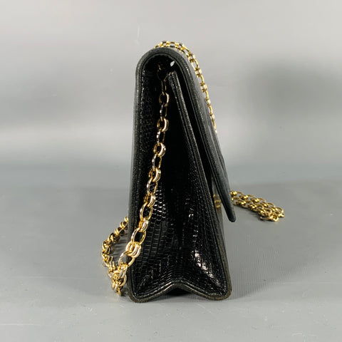 Side profile of the black lizard leather bag showing its gusseted construction and gold-tone chain strap.