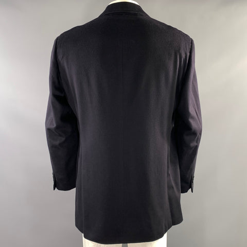 Back view of the black sport coat showing the center back seam and long hem.