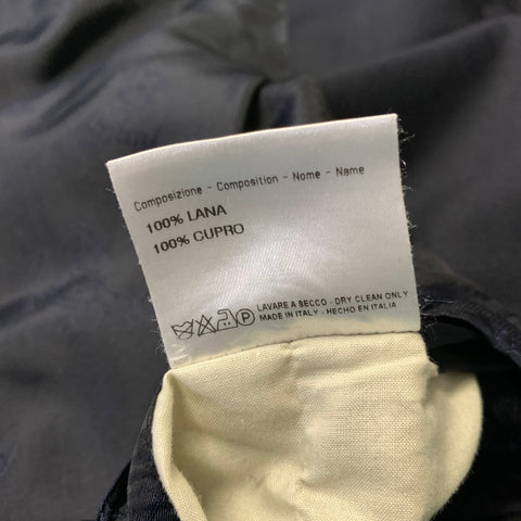 Interior composition label stating 100% lana and 100% cupro, with dry-clean-only care instructions.
