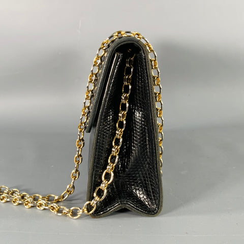 Side view of the black bag with gold-tone chain strap and folded gusset.