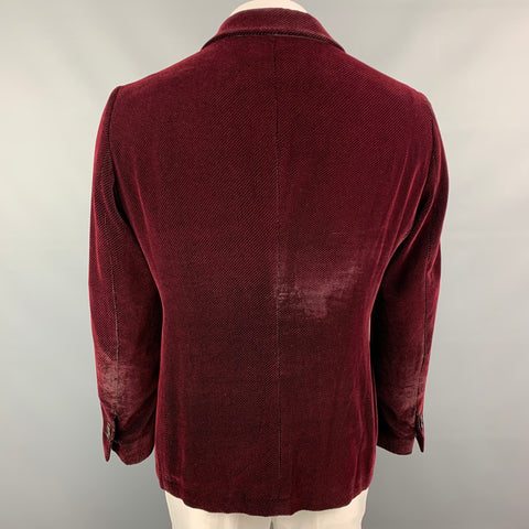Back view of burgundy and black houndstooth sport coat.