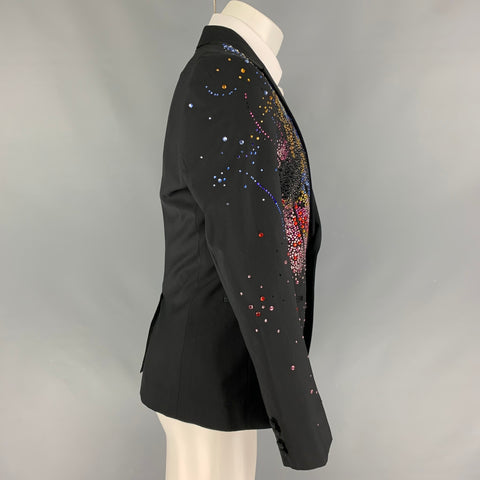 Side view of black beaded sport coat showing embellished shoulder and sleeve, single-button front, and cuff buttons.