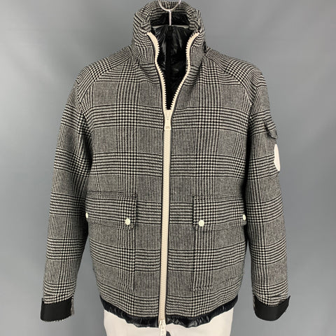 Black and white plaid Moncler jacket shown from the front with the white zip closure fastened.