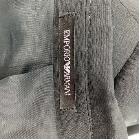 Close-up of black Emporio Armani interior brand label sewn into the garment.