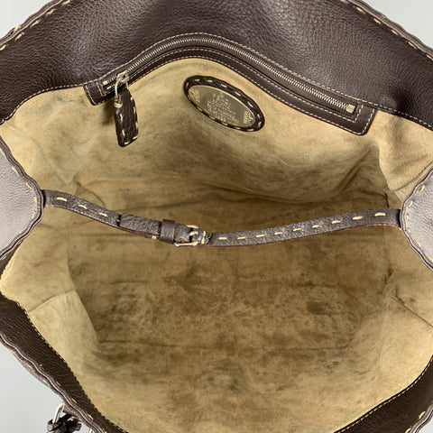 Open interior view showing the light suede lining, zip pocket, interior plaque, and top closure strap.