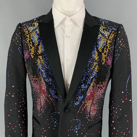 Close front view of black peak-lapel sport coat showing dense blue, gold, pink, red, and black bead embellishments.
