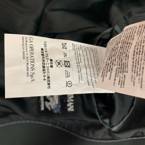Close-up of Emporio Armani garment care and manufacturer labels, including laundry-care symbols.