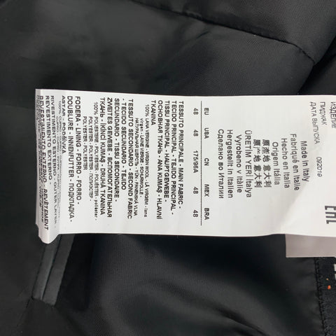 Close-up of interior care label showing Made in Italy, size 48, and multilingual fabric-content text.