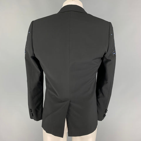 Back view of black sport coat showing plain back panel, center seam, and subtle bead accents at the outer shoulders.