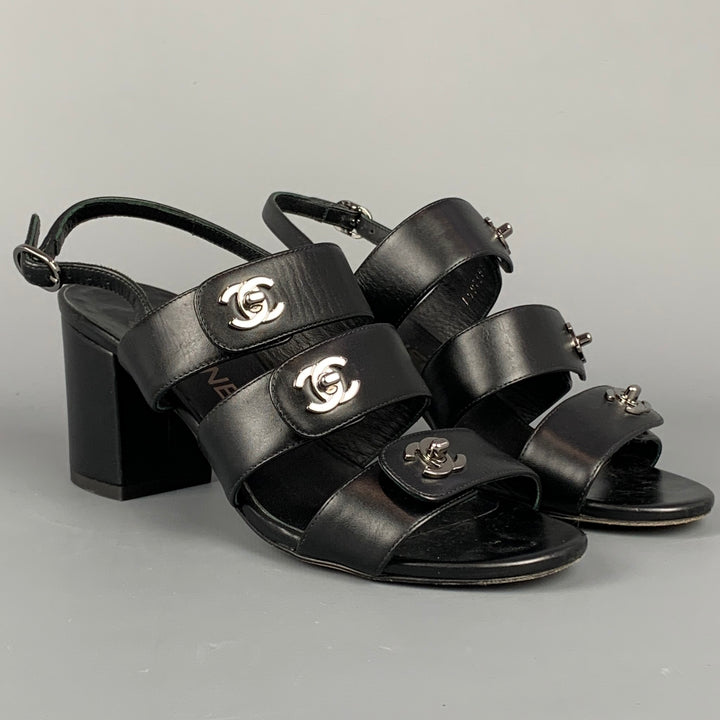 CHANEL Size 6 Black & Silver Leather Turn Lock Logo Chunky Heel Sandals