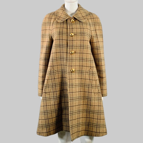 Plaid coat on a mannequin against a gray background