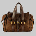 YVES SAINT LAURENT Brown Shearling Leather Shoulder Handbag with gold-tone metal hardware, side pockets with buckle closure, and a magnetic closure.