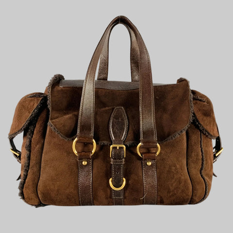 YVES SAINT LAURENT Brown Shearling Leather Shoulder Handbag with gold-tone metal hardware, side pockets with buckle closure, and a magnetic closure.
