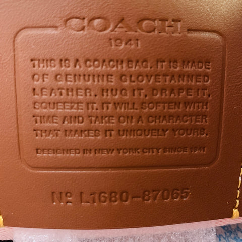 Sac à main en cuir noir COACH avec applique florale rose