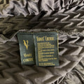 Close-up of VANITE COUTURE label and care label on pleated fabric.