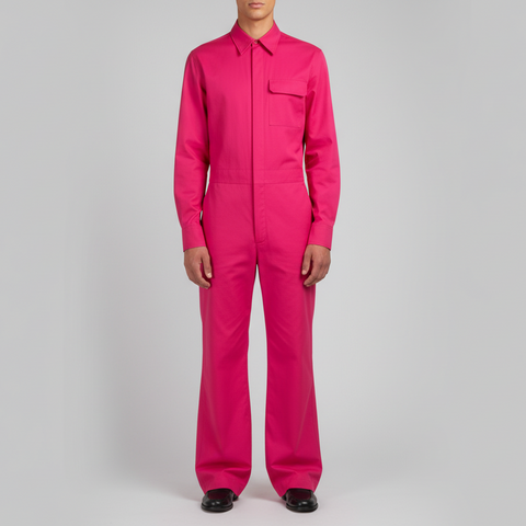 Person wearing a bright pink jumpsuit on a gray background