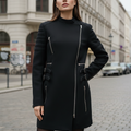 Black coat with zippers on a mannequin against a gray background