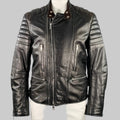Black and brown quilted leather motorcycle jacket with zip pockets and quilted shoulders, displayed on a mannequin.