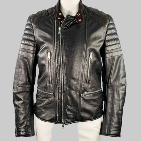 Black and brown quilted leather motorcycle jacket with zip pockets and quilted shoulders, displayed on a mannequin.