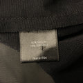 Close-up of fabric content label stating 82% nylon and 18% spandex.