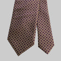 Purple and gold patterned tie on a gray background