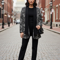 Black and white patterned jacket on a mannequin against a gray background
