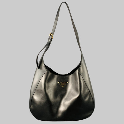 Black calf leather PRADA 'City' hobo handbag with an adjustable shoulder strap and a signature triangle logo.
