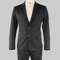 Black suit jacket with white shirt on a gray background