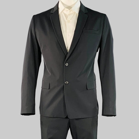 Black suit jacket with white shirt on a gray background