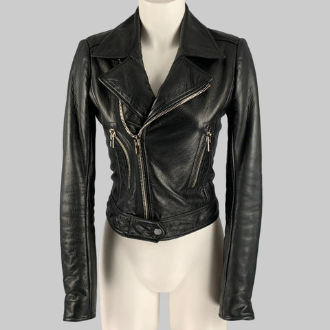 Black leather jacket on a mannequin against a gray background