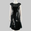 A black wool silk sequined shift dress with a sheer back and a tulle train, size 2.