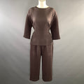 Front full view of brown chevron-pleated top and wide-leg pants set on mannequin.