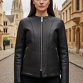 Black leather jacket on a mannequin against a gray background