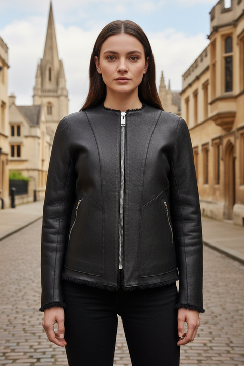 Black leather jacket on a mannequin against a gray background