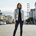 Vintage silver leather jacket with hand painted applique and a brass zip up closure, featuring floral and musical instrument designs.