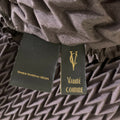 Close-up of VANITE COUTURE brand label and Made in Hong Kong tag.