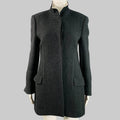 Gray coat on a mannequin against a gray background