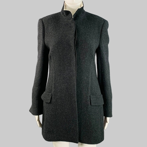Gray coat on a mannequin against a gray background