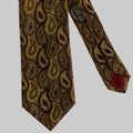 Patterned tie with a visible brand label on a light gray background