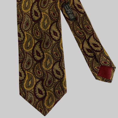Patterned tie with a visible brand label on a light gray background